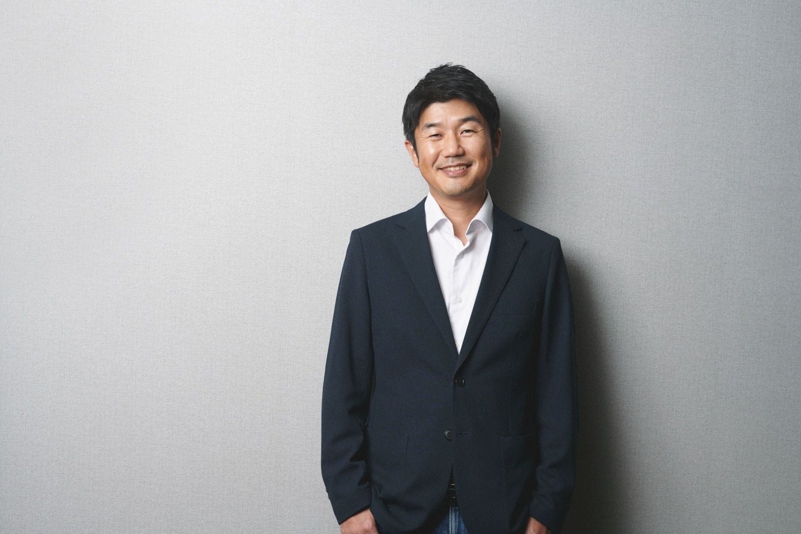 Professional headshot for Hololive founder and CEO Motoaki Tanigo